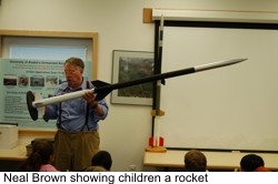 Neal showing a rocket to the children