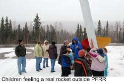 Children feeling a model rocket